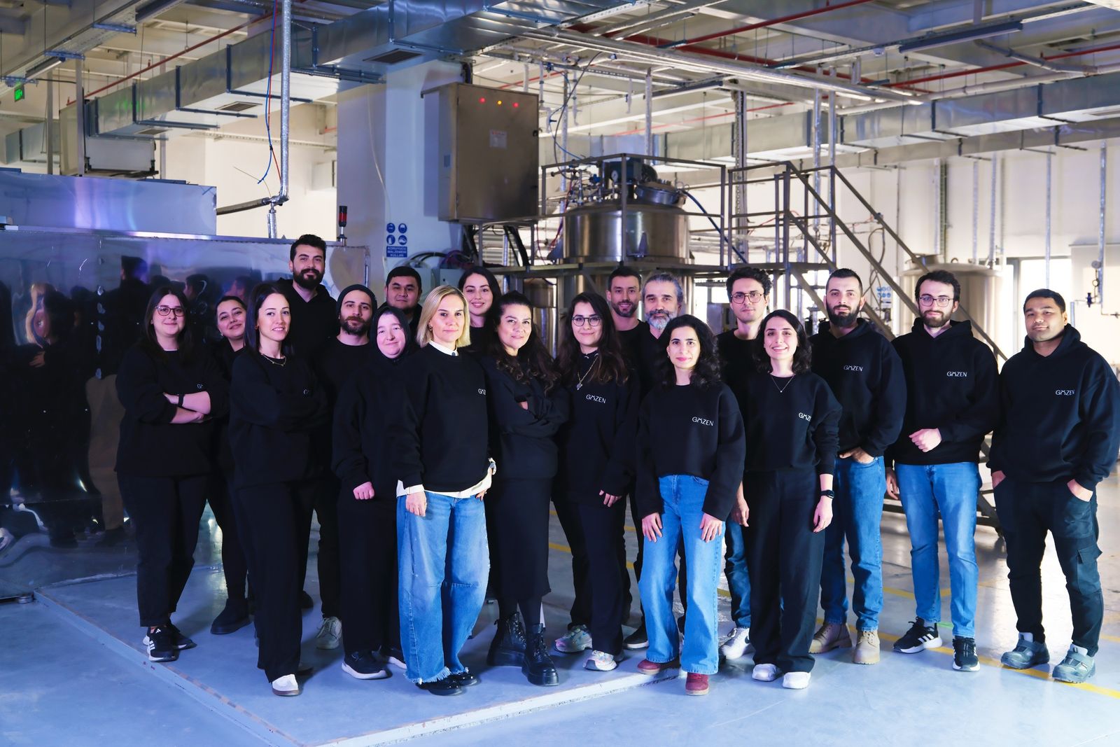 The NUERA team standing together in the production hall