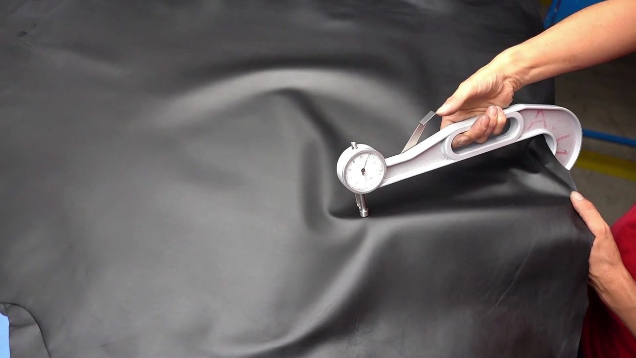 A hand smoothing LUNAFORM™ on the finishing line at the Corlu tannery