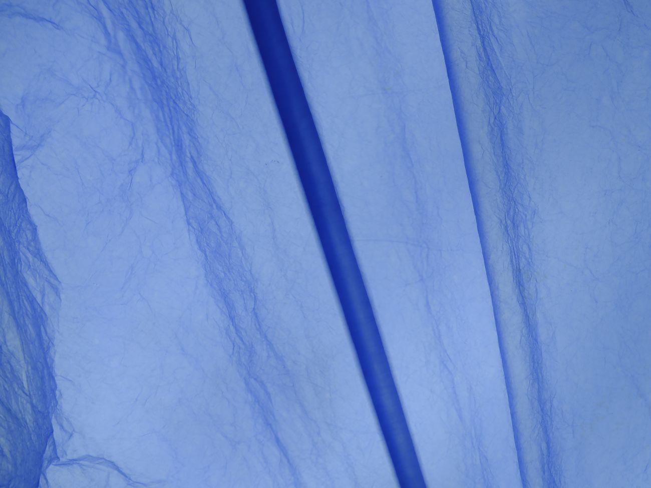 Translucent blue LUNAFORM™ draped over an arm